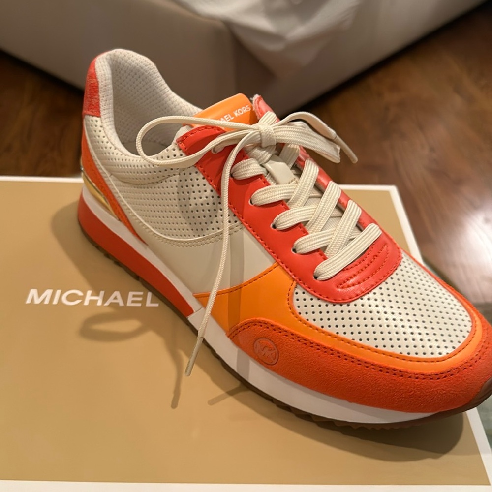 MichaelKors orange & white sneakers. Cushioned footbed, brand logo gold hardware